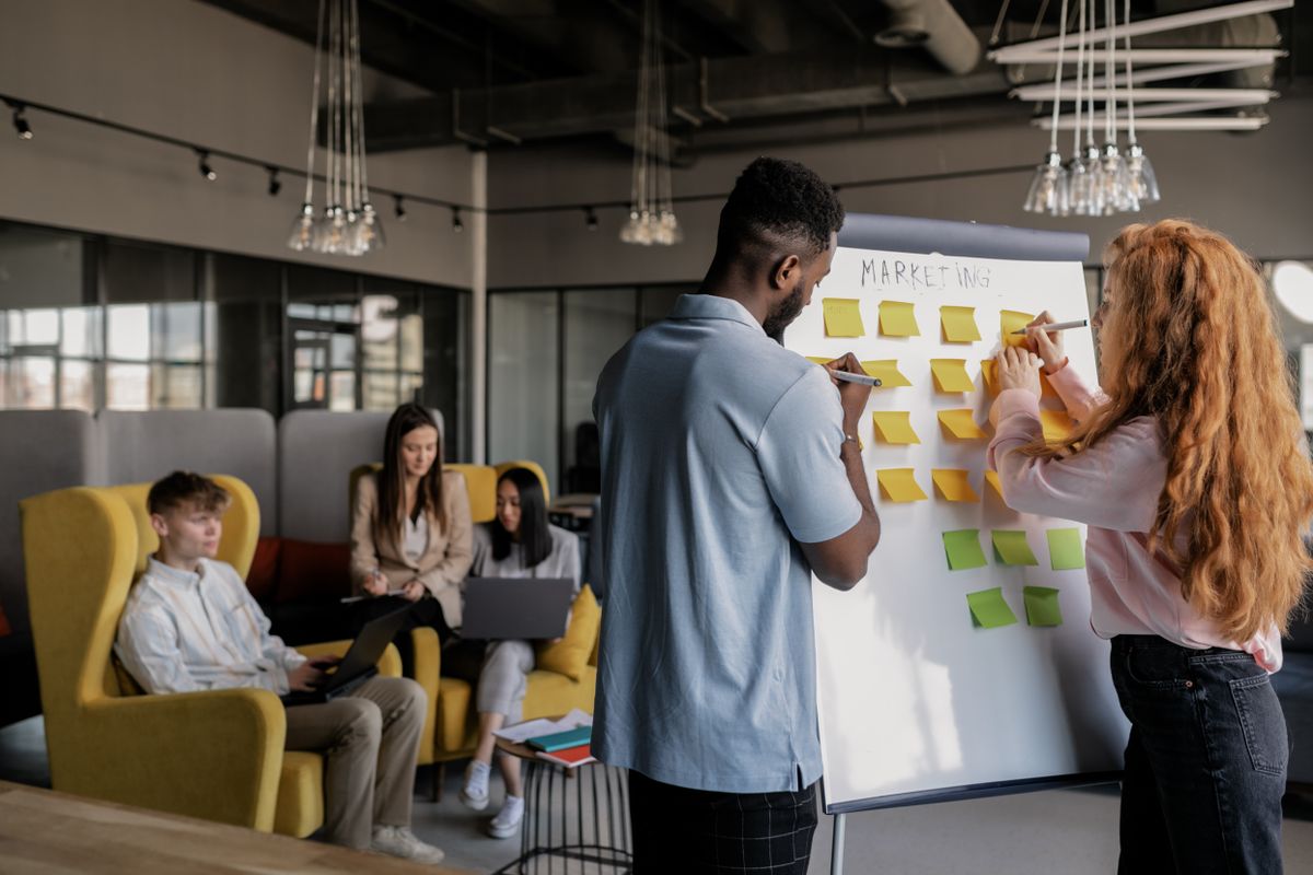 Team planning together at a whiteboard with sticky notes